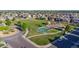 Aerial view of a community park with a playground and basketball court surrounded by single-Gathering homes at 12652 Glencoe St, Thornton, CO 80241