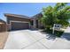 Single-story home featuring a two-car garage and landscaping at 12652 Glencoe St, Thornton, CO 80241