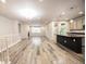 Open-concept living area with wood floors, fireplace, and kitchen island at 12652 Glencoe St, Thornton, CO 80241