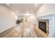 Open-concept living area with fireplace, kitchen with island and durable flooring at 12652 Glencoe St, Thornton, CO 80241