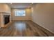 Cozy living room with a stone fireplace and large window at 12652 Glencoe St, Thornton, CO 80241