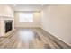 Bright living room with wood floors, a stone fireplace and large window at 12652 Glencoe St, Thornton, CO 80241