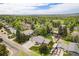 A beautiful aerial view of a home surrounded by lush trees in a vibrant neighborhood at 10482 W 75Th Ave, Arvada, CO 80005