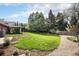 Expansive backyard with mature trees and lush green grass offers privacy at 10482 W 75Th Ave, Arvada, CO 80005