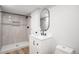 Updated bathroom features a modern vanity, updated shower with modern tile at 10482 W 75Th Ave, Arvada, CO 80005