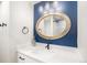 Contemporary bathroom with quartz countertops, modern fixtures, and a unique mirror at 10482 W 75Th Ave, Arvada, CO 80005
