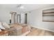 Neutral bedroom featuring a ceiling fan, new floors and a walk in closet at 10482 W 75Th Ave, Arvada, CO 80005