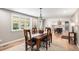 Bright dining area with view into kitchen and a large window overlooking the yard at 10482 W 75Th Ave, Arvada, CO 80005