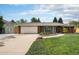 Charming single-story home with well-manicured lawn and attached garage at 10482 W 75Th Ave, Arvada, CO 80005