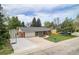 An aerial view of a charming single-story home with a basketball court and green lawn at 10482 W 75Th Ave, Arvada, CO 80005