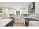 Modern kitchen featuring white cabinets, stainless steel appliances, and a farmhouse sink at 10482 W 75Th Ave, Arvada, CO 80005