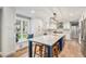 Beautiful kitchen with white cabinets, large island, window seat, and modern lighting at 10482 W 75Th Ave, Arvada, CO 80005