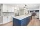 Bright kitchen with a large blue island, stainless steel appliances, and decorative backsplash at 10482 W 75Th Ave, Arvada, CO 80005