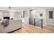 An open-concept living room featuring hardwood floors, modern decor, and a staircase at 10482 W 75Th Ave, Arvada, CO 80005