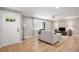 A cozy living room featuring hardwood floors, neutral colors, a front door, and natural light at 10482 W 75Th Ave, Arvada, CO 80005