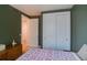 Bedroom with a queen bed, double door closet and access to hallway at 8588 W Quarles Pl, Littleton, CO 80128