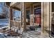 Inviting front porch with stone accents and seating area at 8588 W Quarles Pl, Littleton, CO 80128