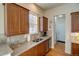 Kitchen features granite countertops, wood cabinets and stainless steel appliances at 8588 W Quarles Pl, Littleton, CO 80128