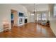 Bright living room with hardwood floors, fireplace, and views into adjacent kitchen at 8588 W Quarles Pl, Littleton, CO 80128