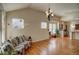 Open concept living room with hardwood floors and kitchen view at 8588 W Quarles Pl, Littleton, CO 80128