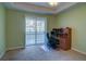 Home office with built-in desk and sliding door to balcony at 8588 W Quarles Pl, Littleton, CO 80128