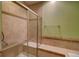 Walk-in shower with built-in seat and neutral tile at 8588 W Quarles Pl, Littleton, CO 80128