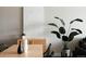 Well-lit dining table with art and a lush plant plus modern decor creating a serene and welcoming space at 2880 Zuni St # 406, Denver, CO 80211