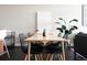 Dining area with modern table and seating, enhanced by artwork, and a soothing plant for an inviting atmosphere at 2880 Zuni St # 406, Denver, CO 80211