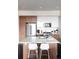 Kitchen featuring stainless steel appliances, modern cabinetry, a peninsula and seating plus plenty of natural light at 2880 Zuni St # 406, Denver, CO 80211