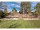 Spacious backyard featuring well-maintained fencing, mature trees, and lush green grass at 7923 S Marion Ct, Centennial, CO 80122