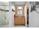 Ensuite bath featuring a glass enclosed shower and vanity with storage cabinets; leads to walk-in closet at 7923 S Marion Ct, Centennial, CO 80122