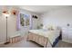 Well-lit bedroom with comfortable queen bed, neutral color scheme and view to the front yard at 7923 S Marion Ct, Centennial, CO 80122