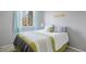 Guest bedroom featuring light-blue curtains, white bedding with green accents, and 'Be Our Guest' sign at 7923 S Marion Ct, Centennial, CO 80122