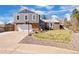 Charming two-story home with a well-maintained lawn, rocking chairs, and a basketball hoop at 7923 S Marion Ct, Centennial, CO 80122