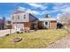 Charming two-story home with a well-maintained lawn, rocking chairs, and a basketball hoop at 7923 S Marion Ct, Centennial, CO 80122