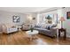 Bright living room with hardwood floors, large windows, and comfortable seating arrangement at 7923 S Marion Ct, Centennial, CO 80122