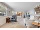 Open concept living room features a fireplace, sliding door to the patio, and view into the kitchen at 7923 S Marion Ct, Centennial, CO 80122