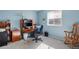 Bright office space with computer desk, shelves, and rocking chair; a functional and well-lit area at 7923 S Marion Ct, Centennial, CO 80122