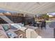 Enjoy outdoor living on this covered patio with comfortable seating and privacy fence at 7923 S Marion Ct, Centennial, CO 80122