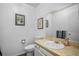Bathroom features a neutral color palette, granite-style counters, and framed art at 13339 E Idaho Pl, Aurora, CO 80012