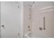 Standard bathroom with white tiles, grab bar and updated shower head at 13339 E Idaho Pl, Aurora, CO 80012