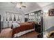 Bedroom with a large bed, mirrored closet, fan, and window at 13339 E Idaho Pl, Aurora, CO 80012