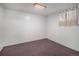 A simple carpeted bedroom with a window, neutral walls, and ample natural light at 13339 E Idaho Pl, Aurora, CO 80012