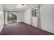 Carpeted bedroom with large windows and sliding door for natural light at 13339 E Idaho Pl, Aurora, CO 80012