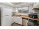 Charming kitchen features white cabinets, wood countertops, stainless steel appliances, and a bright window at 13339 E Idaho Pl, Aurora, CO 80012