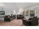 Bright living room featuring large windows, neutral carpet and two comfortable sofas at 13339 E Idaho Pl, Aurora, CO 80012