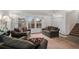 Bright living room featuring large windows, neutral carpet and two comfortable sofas at 13339 E Idaho Pl, Aurora, CO 80012