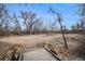 View of bridge leading to a park area with bare trees and a dirt terrain at 13339 E Idaho Pl, Aurora, CO 80012