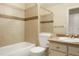 Tiled bathroom featuring a bathtub, toilet, vanity, and stylish fixtures at 5711 W 92Nd Ave # 30, Westminster, CO 80031