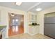 Open-concept kitchen view with stainless steel refrigerator, tile flooring, and adjoining living space at 5711 W 92Nd Ave # 30, Westminster, CO 80031